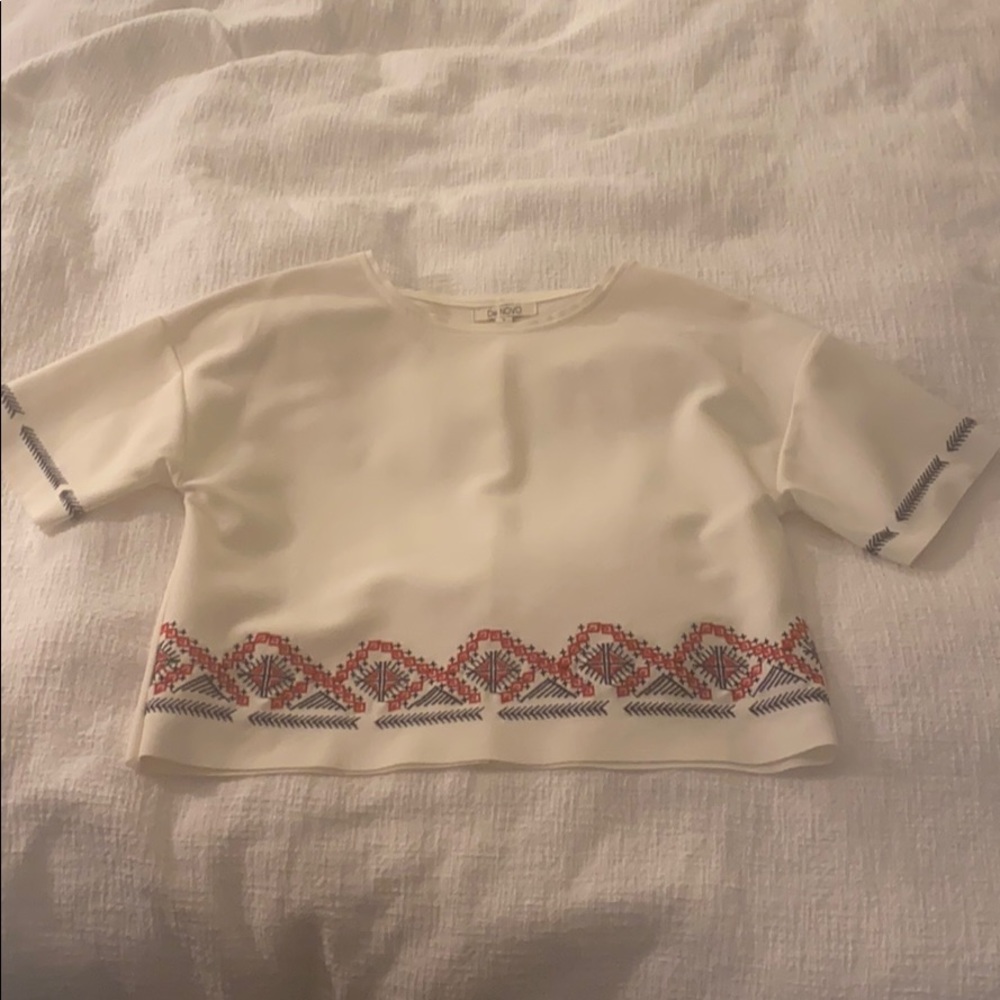 White top with embroidered accents